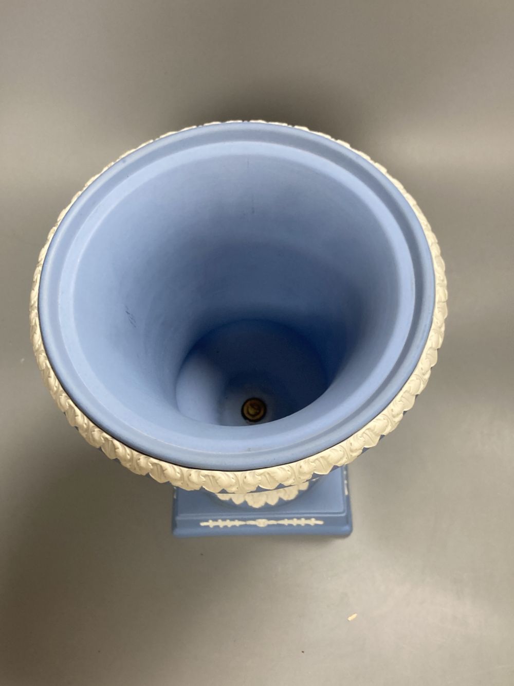 A 20th century Wedgwood light blue jasperware two-handled campagna-shaped urn and cover,